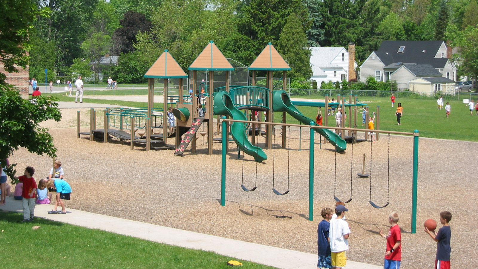 Officer Wallace holding Riding for Ryan flag and Ryan's mom in front of Public Safety