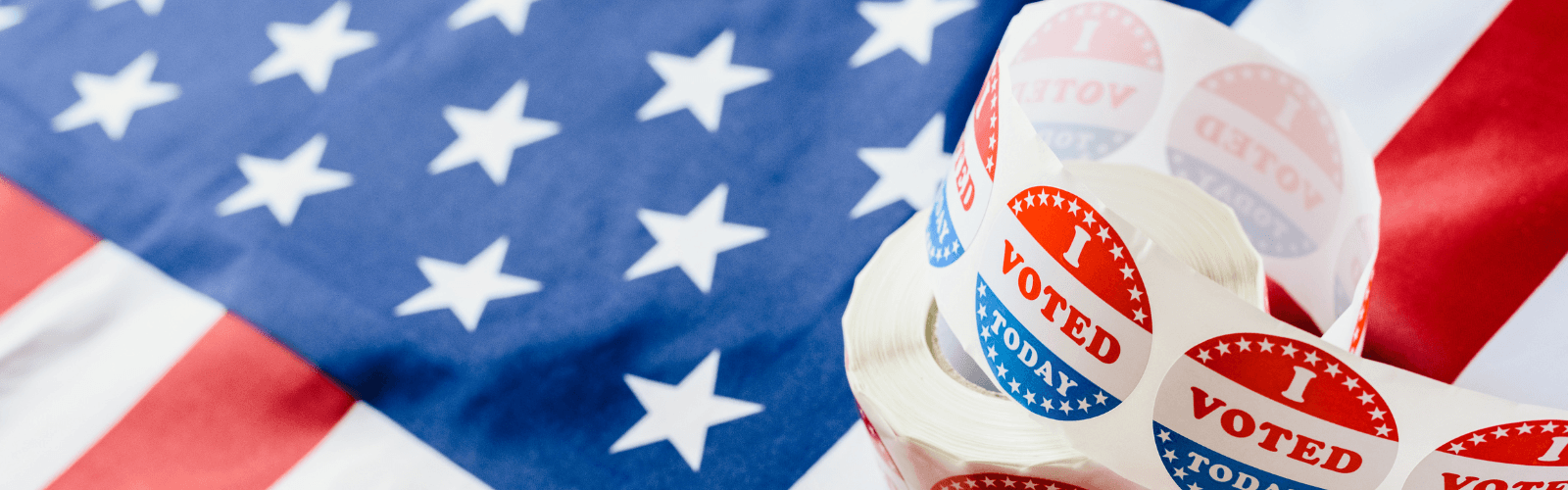 "I voted today" sticker on American flag background.