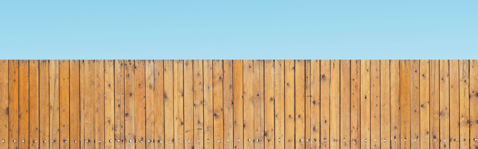Wood fence against a blue sky background
